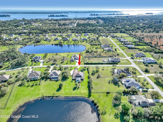 birds eye view of property featuring a residential view and a water view