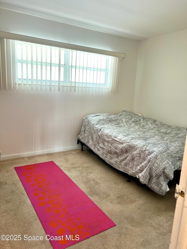 bedroom with carpet flooring and baseboards