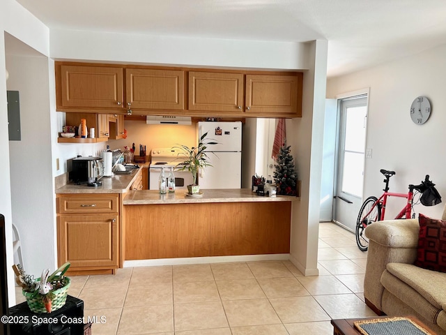 kitchen featuring white appliances, exhaust hood, brown cabinets, and light tile patterned floors