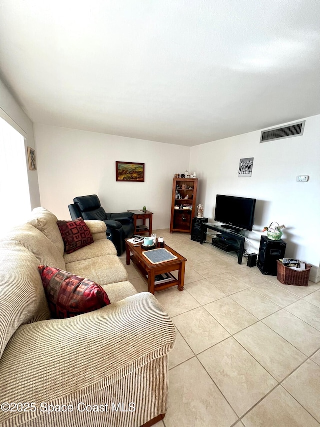 living room featuring light tile patterned floors and visible vents