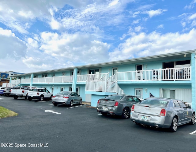 view of building exterior featuring uncovered parking