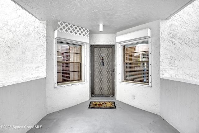 property entrance featuring stucco siding