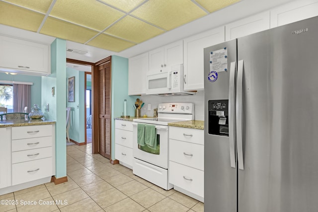 kitchen featuring visible vents, light tile patterned floors, light stone counters, white appliances, and white cabinetry