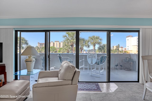 carpeted living room featuring crown molding and a wealth of natural light