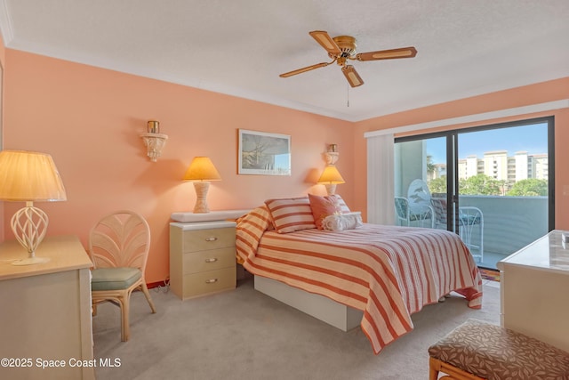 bedroom featuring access to exterior, light colored carpet, crown molding, and a ceiling fan