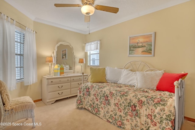 bedroom with light colored carpet, ceiling fan, baseboards, and ornamental molding