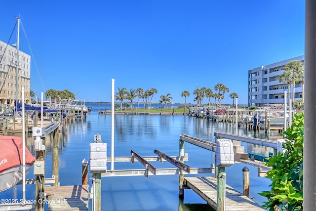 dock area with a water view and boat lift