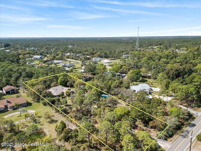 drone / aerial view featuring a view of trees