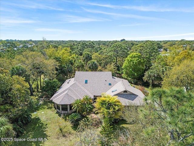 drone / aerial view with a view of trees