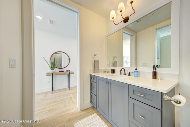 bathroom featuring vanity, baseboards, and visible vents