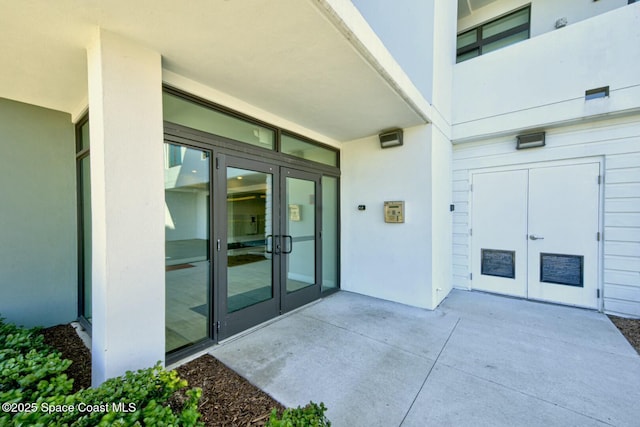 doorway to property with french doors and stucco siding