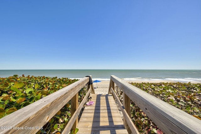 view of community with a beach view and a water view