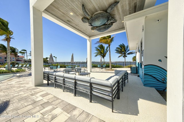 view of patio / terrace featuring an outdoor living space, fence, and ceiling fan