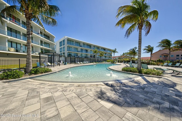 community pool featuring a patio area and fence