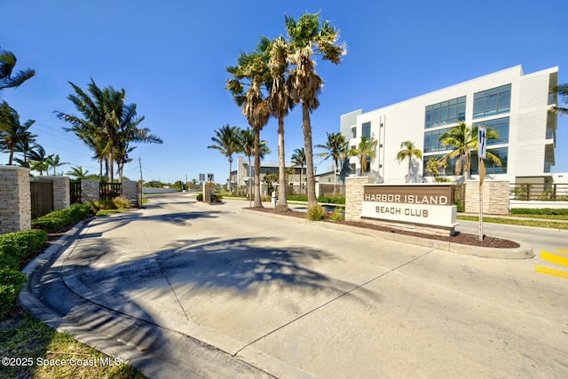 view of street with curbs, a residential view, and a gated entry