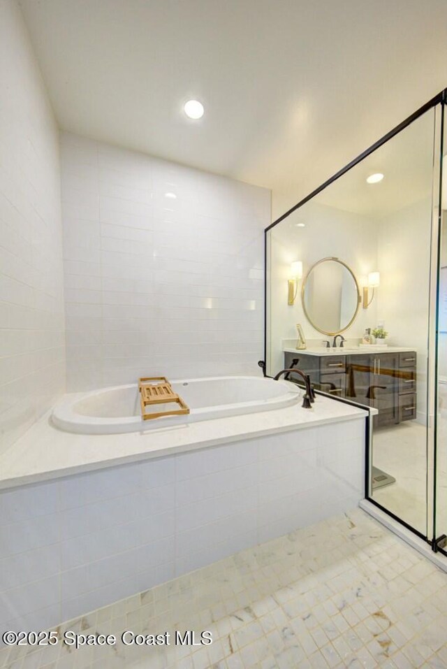 full bath with vanity, recessed lighting, an enclosed shower, tile walls, and a bath