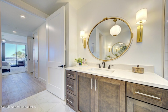 bathroom with vanity, recessed lighting, and marble finish floor