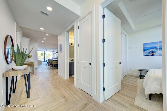 hall featuring parquet flooring, recessed lighting, visible vents, and baseboards