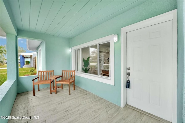 exterior space featuring stucco siding and a porch