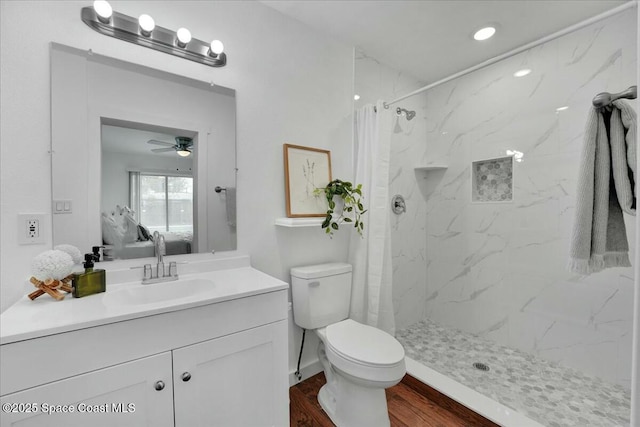 full bathroom with vanity, wood finished floors, a marble finish shower, ensuite bath, and toilet