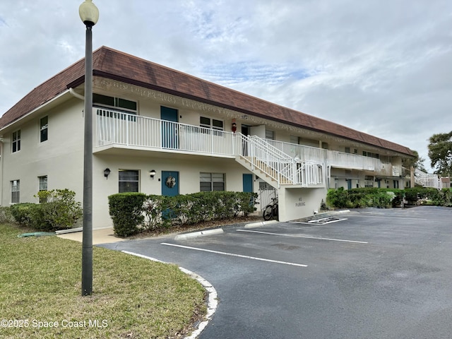 view of property featuring uncovered parking