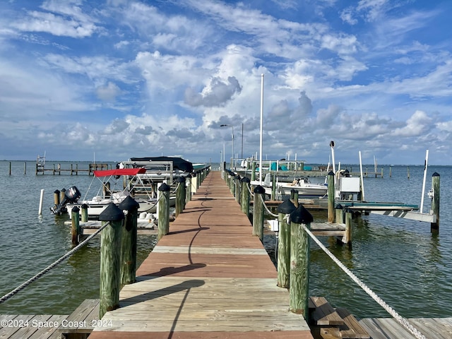 dock area with a water view and boat lift