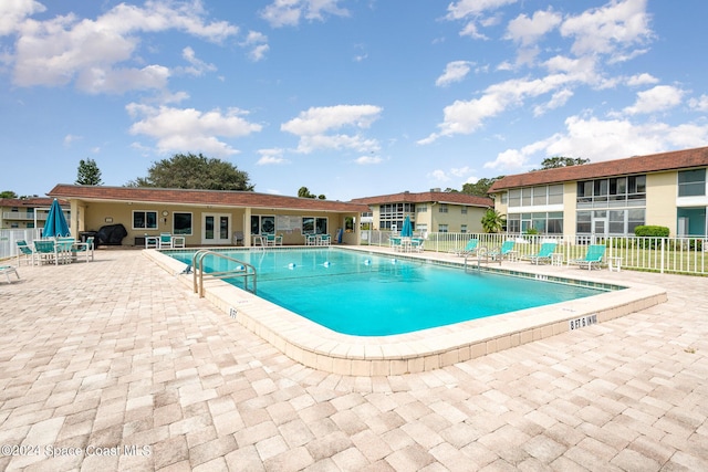 community pool featuring a patio area and fence