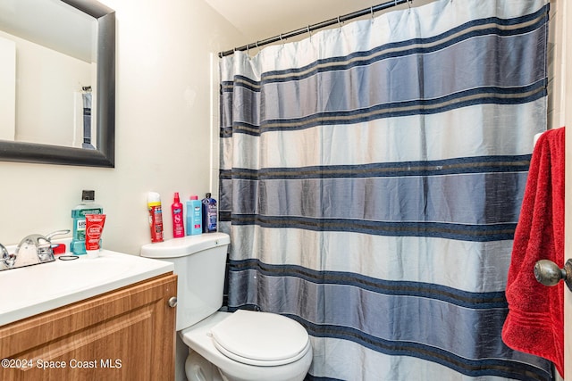 bathroom with vanity, toilet, and a shower with curtain