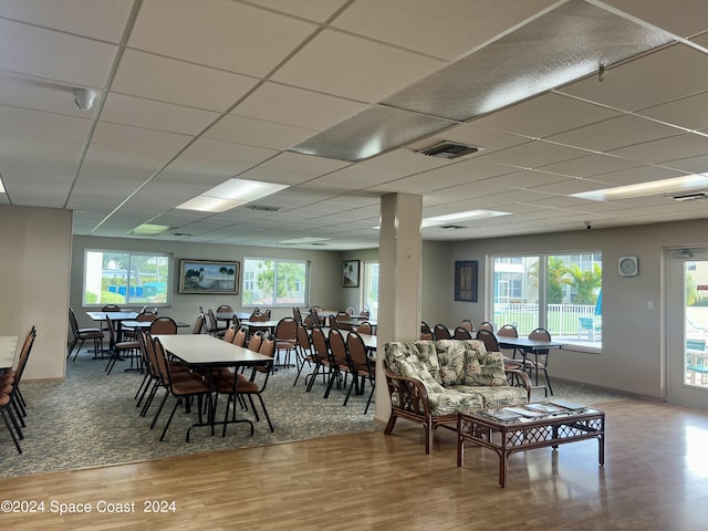 dining space featuring wood finished floors, visible vents, and a drop ceiling