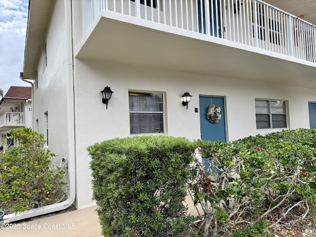 doorway to property featuring stucco siding