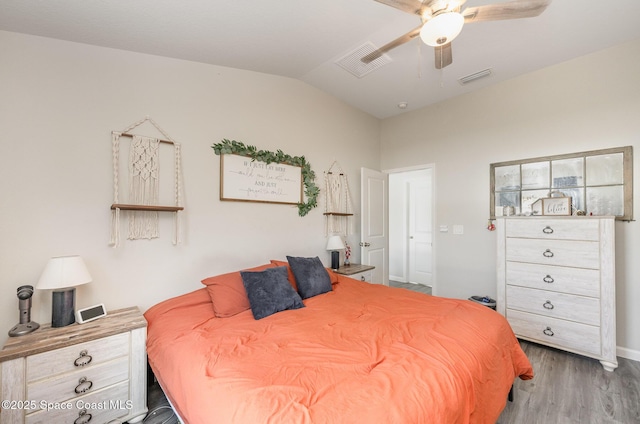 bedroom featuring visible vents, wood finished floors, a ceiling fan, and vaulted ceiling