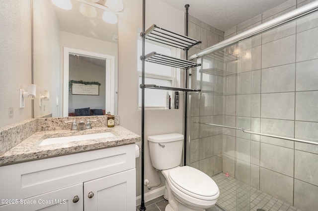 full bathroom with vanity, toilet, a stall shower, and connected bathroom