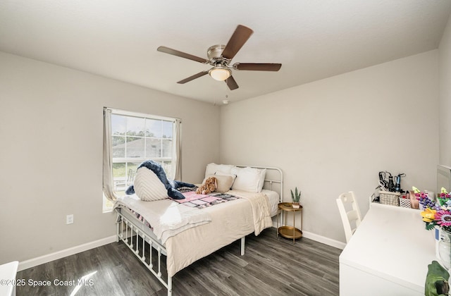 bedroom featuring dark wood finished floors, a ceiling fan, and baseboards