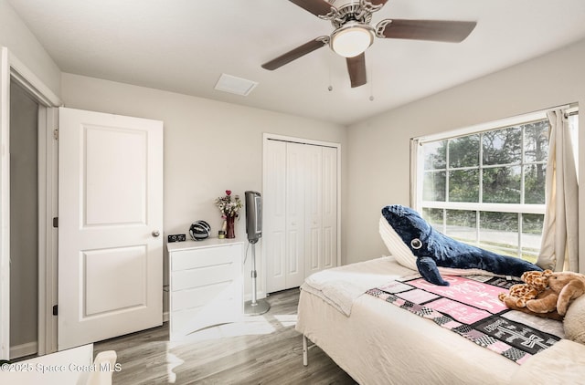 bedroom featuring visible vents, wood finished floors, a closet, and ceiling fan