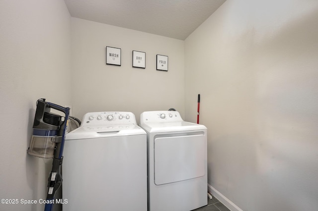 washroom with laundry area, washer and dryer, and baseboards