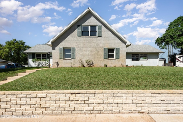 3530 Alan Dr, Titusville, FL 32780 - view of front of property with a front yard and brick siding