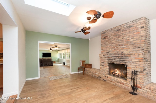 3530 Alan Dr, Titusville, FL 32780 - unfurnished living room with a skylight, wood finished floors, a brick fireplace, and ceiling fan