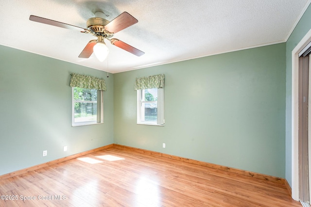 3530 Alan Dr, Titusville, FL 32780 - empty room featuring crown molding, baseboards, wood finished floors, a textured ceiling, and a ceiling fan