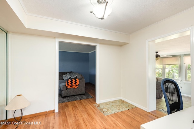 3530 Alan Dr, Titusville, FL 32780 - office area featuring light wood-style flooring, a textured ceiling, crown molding, baseboards, and ceiling fan