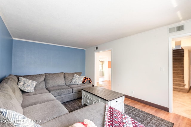 3530 Alan Dr, Titusville, FL 32780 - living room featuring visible vents, wood finished floors, stairway, crown molding, and baseboards