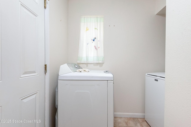 3530 Alan Dr, Titusville, FL 32780 - clothes washing area with washing machine and clothes dryer, laundry area, and baseboards