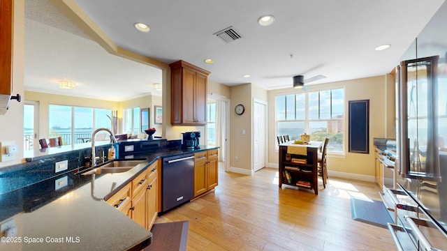 kitchen featuring dishwashing machine, visible vents, recessed lighting, a sink, and light wood-style floors