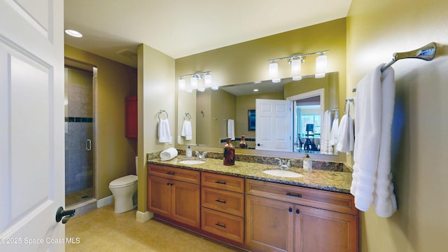 bathroom with a sink, double vanity, a shower stall, and tile patterned flooring