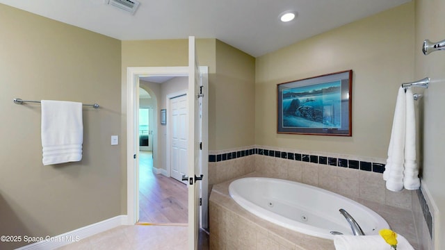 full bathroom featuring visible vents, baseboards, a whirlpool tub, recessed lighting, and tile patterned floors