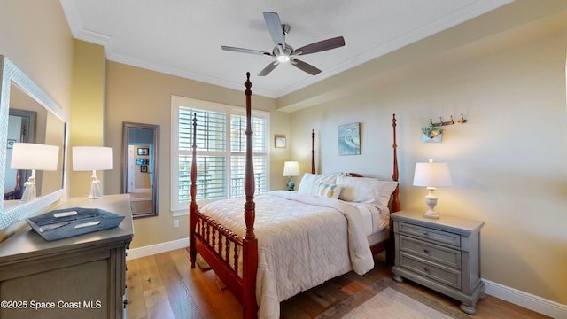 bedroom with light wood-style flooring, baseboards, and ornamental molding