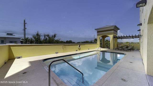 view of swimming pool with a patio area