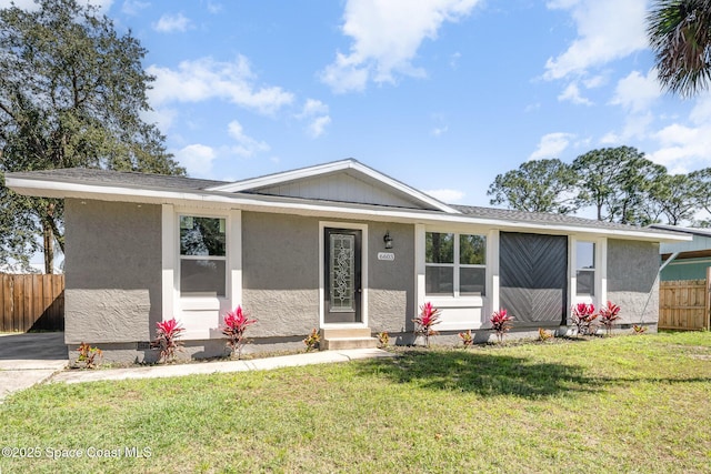 view of front of house with fence, a shingled roof, stucco siding, a front lawn, and crawl space