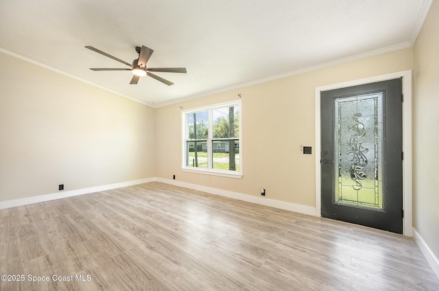 foyer with a ceiling fan, baseboards, light wood-style floors, and crown molding