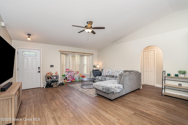 living room with lofted ceiling, wood finished floors, and a ceiling fan