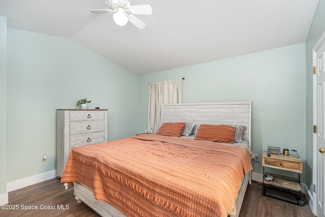 bedroom with vaulted ceiling, wood finished floors, baseboards, and ceiling fan